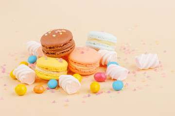 Fototapeta na wymiar Macarons and sweets on a colored background. Festive mood