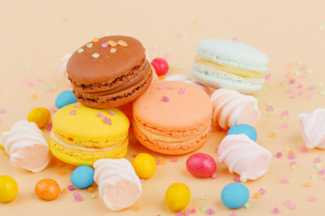 Macarons and sweets on a colored background. Festive mood