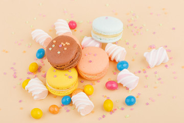 Macarons and sweets on a colored background. Festive mood
