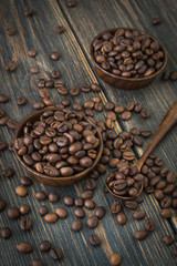 A wooden plate of roasted arabica coffee beans