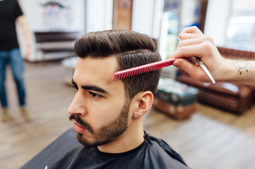 male model shows a haircut in a barber shop