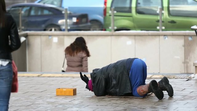 Homeless man begs for money
