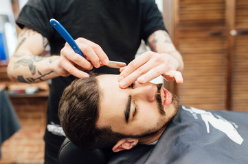 Barber shave and modeling beard at the hair salon