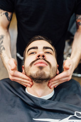 Obraz na płótnie Canvas Barber master prepares face of client for shaving