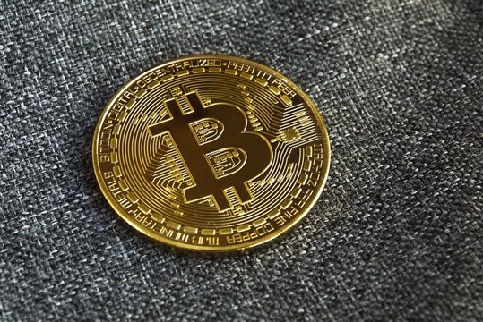 Golden bitcoin with elegant textile texture background