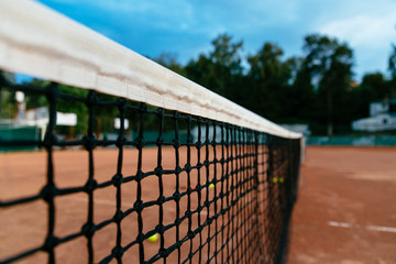 Tennis net on a tennis court background. Close-up.