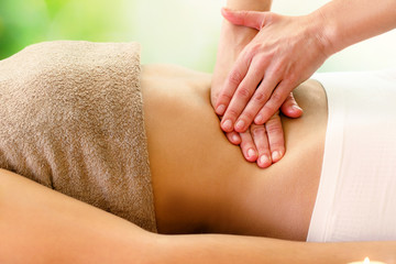 Kinesiologist applying pressure on stomach.