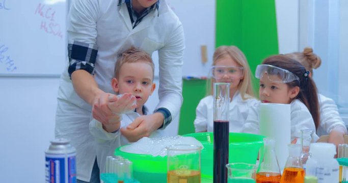Teacher showing experiment how fire burning on their hands. Teacher explaining an experiment to a high school chemistry class together