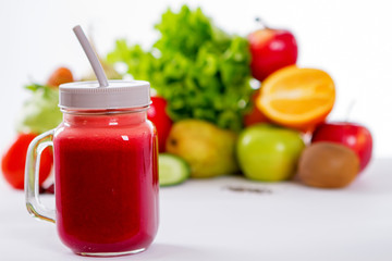 Vegetable smoothie in small bottles, dark wood background, selective focus