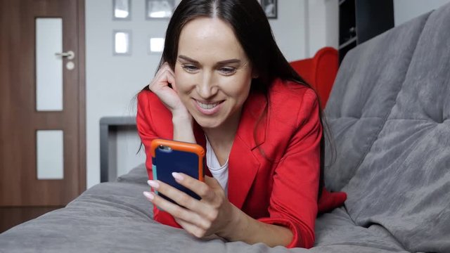 Female relaxing on the settee with telephone