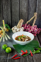 Oxtail soup in white dish on brown wood, Delicious Esan Thai food, Isan food