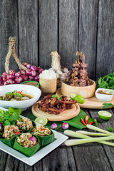 Spicy Raw Ant Eggs Salad, Oxtail soup, grilled ox tongue, deep fried beef on the table with herbs