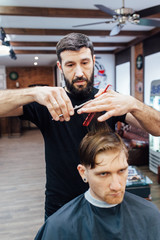 man getting trendy haircut at barber shop.