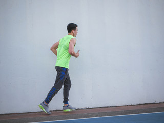 Young asian man running in park, Healthy lifestyle concept.