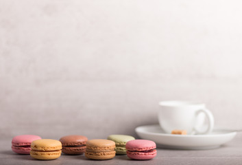 assortment of colorful macaroons with a cup of coffee