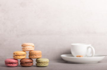 assortment of colorful macaroons with a cup of coffee