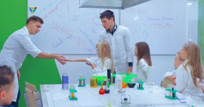 Teacher showing experiment how fire burning on their hands. Teacher explaining an experiment to a high school chemistry class together