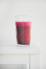 Fresh morning beetroot smoothie or juice in glass, white background, copy space. Healthy vegan or vegetarian breakfast, seasonal detox, clean eating, alcaline diet, weight loss food concept