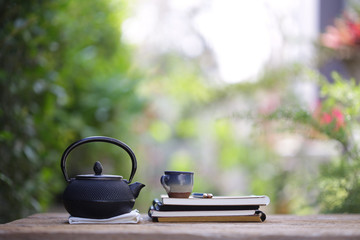 Obraz na płótnie Canvas Black vintage teapot and cup at outdoor