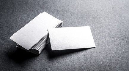 Stack of blank white business card on grey background. Blank name card.
