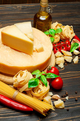 Traditional Italian parmesan or parmigiano cheese, pasta, tomatoes and olive oil