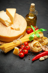 Traditional Italian parmesan or parmigiano cheese, pasta, tomatoes and olive oil