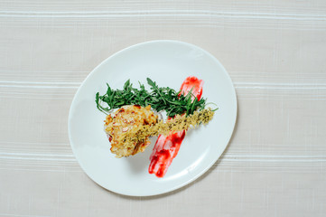 tender exquisite salad with turkey melange sun-dried tomatoes and greens in a white plate on a white tablecloth