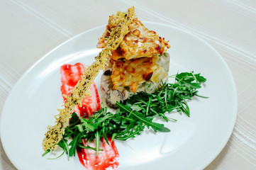 tender exquisite salad with turkey melange sun-dried tomatoes and greens in a white plate on a white tablecloth