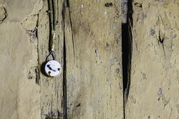 Old light switcher at the wooden wall