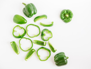 Sliced and whole bell pepper.fresh green vegetable.white background.minimalistic styling image.top view