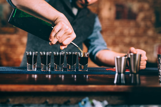Close up details of bartender serving alcoholic drinks at party