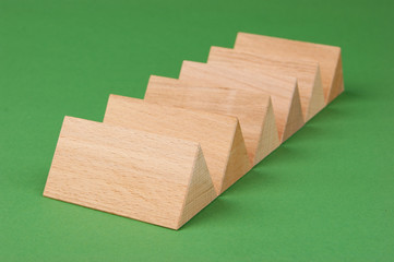 wooden geometric shapes on a green background