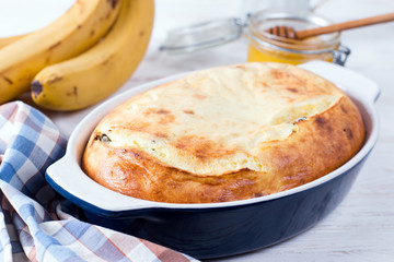 Casserole of cottage cheese with raisins on white background