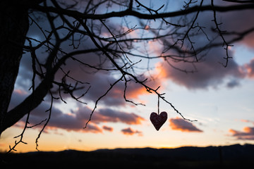 Dark heart, sunset sky in background, valentine photo, edit space
