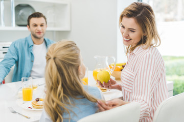 Obraz na płótnie Canvas happy family having breakfast together at home