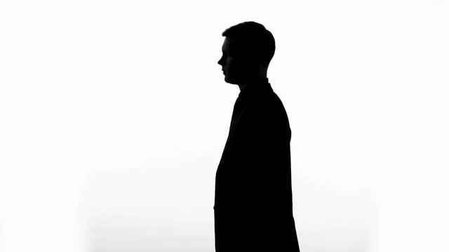 Profile silhouette of man showing gesture of silence, censorship, confidential