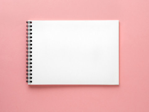 Blank Notepad White Page On Pink Desk, Color Background. Top View,  Flat Lay.