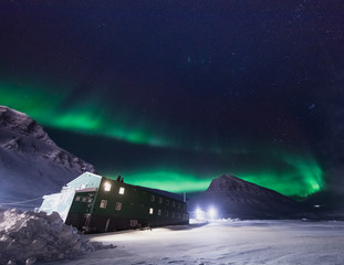 The polar arctic Northern lights aurora borealis sky star in Norway Svalbard in Longyearbyen city snowscoter  mountains