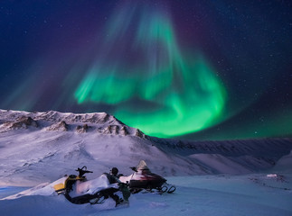 The polar arctic Northern lights aurora borealis sky star in Norway Svalbard in Longyearbyen city snowscoter  mountains