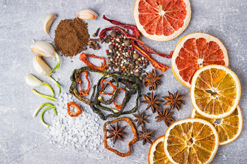 Spices on the stone gray background. Condiments on a dark table. Seasoning for cooking.