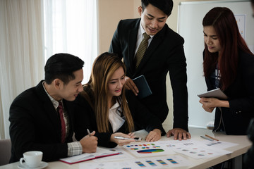 Groups of businessman hands pointing to a  graph in the meeting while discussing marketing business.