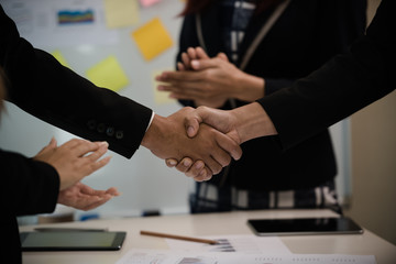 A group of Asian Business handshake of congratulations on meeting the business achieve success.