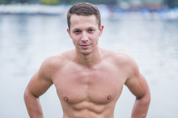 Fototapeta na wymiar Young athletic caucasian man posing on the beach