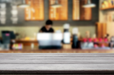Selected focus empty brown wooden table and Coffee shop or restaurant blur background with bokeh image. for your photomontage or product display.