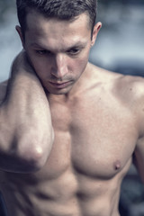 Fototapeta premium Young athletic caucasian man posing on the beach