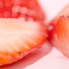 sliced strawberry fruit isolated on pink background, pop art color concept