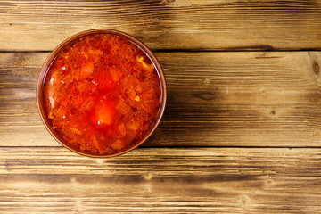 Ukrainian and Russian traditional beetroot soup - borscht on wooden table