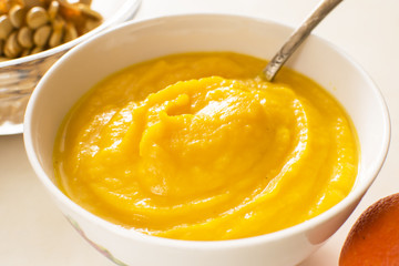 orange cream soup in a bowl, on a table