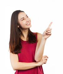 Smiling young woman pointing up