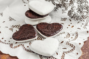 Sweet cookies in the form of hearts from gingerbread dough chocolate and a white glaze. Traditional cookies. Copy space
